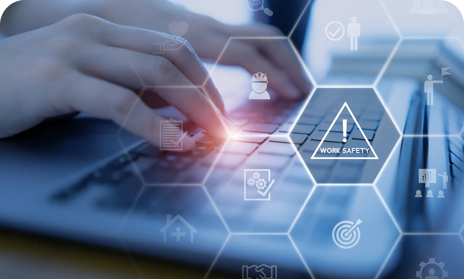 Grayson Risk Consulting Hands typing on a laptop keyboard with hexagonal overlay graphics highlighting work safety and related icons.
